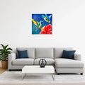 mysilence art acrylic art piece with colorful hummingbirds and red flower above modern grey sofa